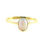 An opal dress ring, the oval opal in a raised basket on a yellow metal band stamped 18ct, ring size