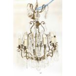A 20thC metal and cut glass eight branch chandelier, with a double central baluster column, with two
