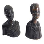 A pair of carved tribal figures of a lady and gentleman, each quarter profile, dressed in finery, 24