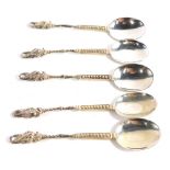 A set of five dragon topped George V silver teaspoons, with elaborate handles, London 1922 and 1923,