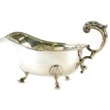 A George V silver sauce boat, Alex Clark and Co, with flying S scroll handle, on triple hoof feet, B