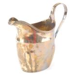 An early 19thC silver cream jug by Christopher Dinsdale I, with plain spout, strapwork handle and pl