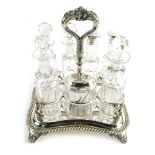 An Edwardian silver plated bottle cruet set, Savory family crest, containing various silver mounted