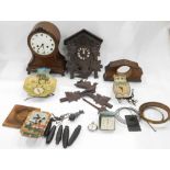 Various clocks, part clocks, clock workings, etc., a Black Forest style cuckoo clock, carved with bi