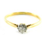 A diamond dress ring, centred with a round brilliant cut diamond, approximately O.08 carats, in claw