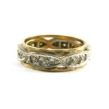 A diamond eternity ring, set with six marquee shaped panels, each set with three tiny diamonds, in a