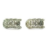 A pair of Art Deco diamond drop earrings, each of a curved drop with four row horseshoe type design,