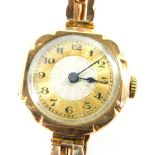 A 9ct gold ladies wristwatch, with a circular watch head with silvered and gold dial with blue hands