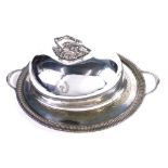 A silver plated meat cover, Savory family crest, with an elaborate scroll handle, marked Goldsmiths