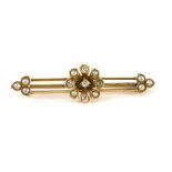 An Art Deco diamond and seed pearl bar brooch, a three bar design with central floral cluster and th