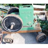 A vintage Crossley Brothers stationary engine, in green with large cogs on truckle base, type PH1019