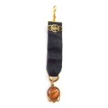 A Masonic type jewel on black silk hanging, with unmarked gold and gold coloured mounts, 12cm high.