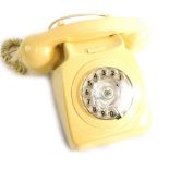 A vintage telephone in ivory colour, numbered 537394, with partial electric feature, 21cm wide recei