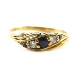 A 9ct gold sapphire and diamond dress ring, set with three sapphires and two diamonds, raised basket