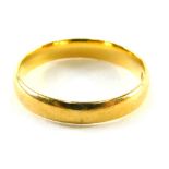 A 22ct gold wedding band of plain design, ring size L, 2.9g.