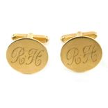 A pair of 9ct gold cuff links, each with a circular head bearing the initials RH, stamped 9ct, 8.9g.