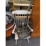 A grandfather style rocking chair and a bird cage