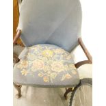 A stick back armchair, on cabriole legs, overstuffed in blue and floral material to the back and sea