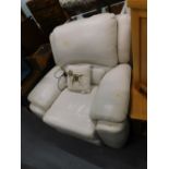 A cream leatherette electric reclining armchair.