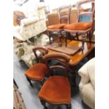 A set of four Victorian mahogany balloon backed dining chairs, each with overstuffed serpentine seat