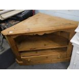 A pine corner TV cabinet, with single drawer on plinth.