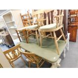 A painted pine refectory style kitchen table and a quantity of beech chairs and a ladder back chair.