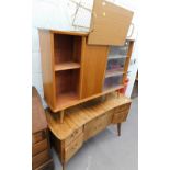 A retro 1960's walnut dressing table with six drawers on shaped legs, (AF) a teak bookcase with slid