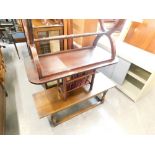 An oak coffee table, magazine rack and mahogany coffee table.