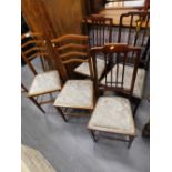 A collection of five Edwardian mahogany and boxwood strung bedroom chairs.