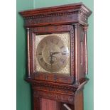 Wainwright, Northampton. An 18thC oak longcase clock, with floral and crescent moon carved hood, sun
