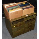 A set of green metal filing drawers, 59cm wide, and various books, to include Practical Home Woodwor