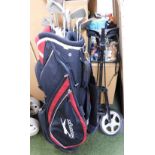 A Slazenger canvas golf bag containing various golf clubs, with trolley.