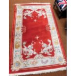 A Chinese wool red ground carpet, approx 150cm x 265cm.