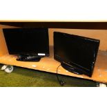 A Logik 18" television with lead and remote, and an Alba 15.5" television, with lead, lacking remote