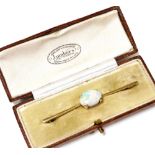 An Edwardian opal bar brooch, set in yellow metal, boxed for Lumbers Ltd of Leicester, 5.0g.
