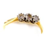 An 18ct gold and diamond three stone ring, high claw set, approx &#8531? ct, size T, 2.5g.