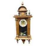 A late 19thC beech cased Vienna wall clock, with painted floral detailing, circular brass dial with