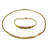 An 18ct three colour gold fringe necklace, together with a matching bracelet, each on a snap clasp,