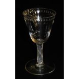 A late Georgian wine glass, the bowl engraved with a repeating star motif, raised on a spiral fluted