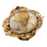 A Victorian hair locket mourning brooch, set in yellow metal, with pin and ring suspension, back eng