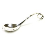 A Georg Jensen silver spoon, pattern 41, with a curved and beaded scrolling handle, impressed marks,