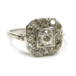 An Art Deco diamond ring, set with old cut diamonds in a cushion setting, in white metal stamped Pla
