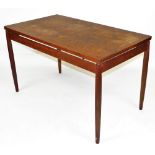 A 1960s teak dining table, possibly Finn Juhl, for France and Son, the rectangular top raised on tur