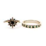 An emerald flower head ring, set in white metal, stamped 585, size L, and an emerald half hoop etern