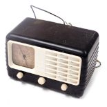 An Ultra brown and white Bakelite cased electric radio, model T401, serial number BD4048, 30cm wide.