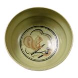 A Carter Stabler Adams Limited Poole celadon pottery trial bowl, decorated with a squirrel and pine