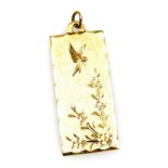 A 9ct gold pendant, of rectangular form, engraved with a hovering bird and flowers, 5.2g.