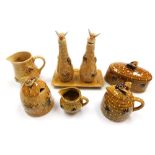 A group of honeybee related pottery, to include butter dish and cover, honey pot, oil dispensers, tr