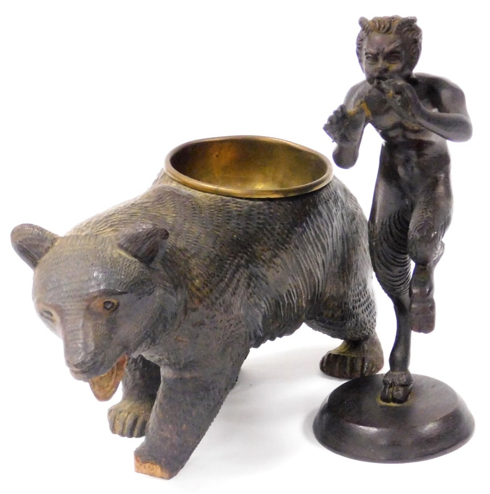 An early 20thC bronze figure of Pan, modelled standing playing his pipes, on a circular base, unsign