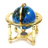 A gem stone terrestrial globe, depicting day and night inset with various semi precious stones, with